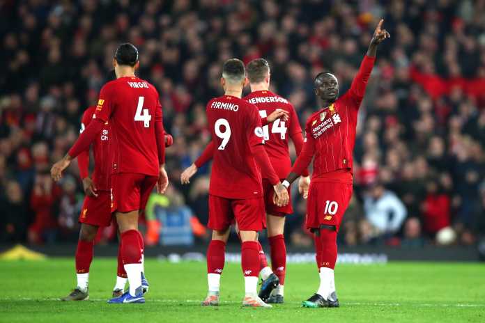 Sadio Mane celebrates with his Liverpool team mates, after scoring the winning goal in the 1-0 win over Wolves. which now sees Liverpool 13 points clear at the top of the Premier League