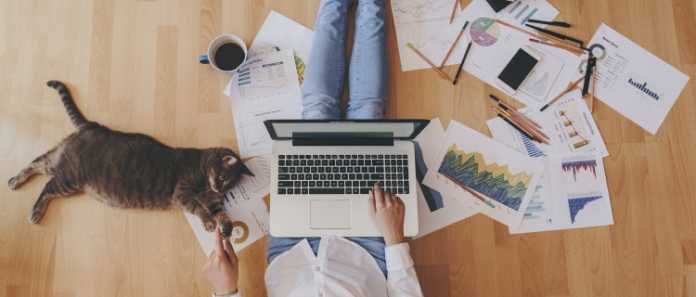 working from home. laptop working paperwork